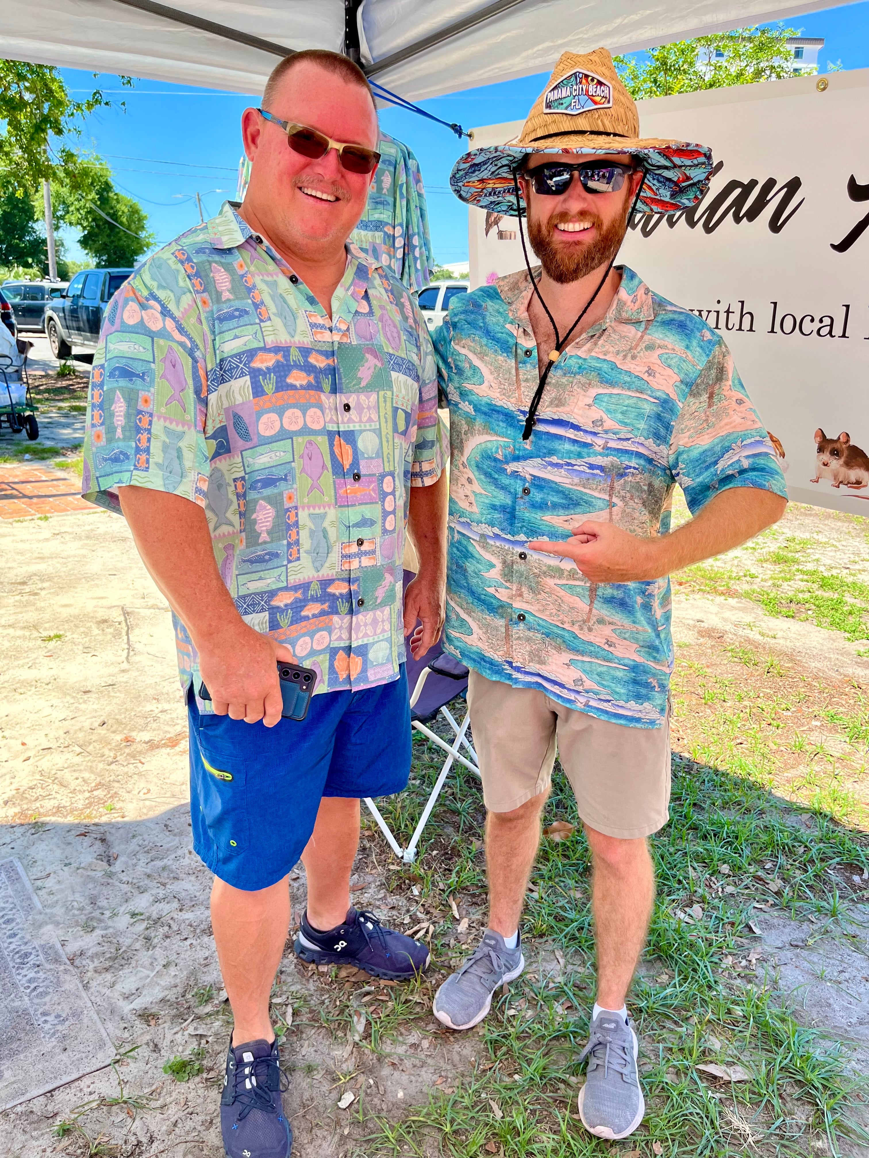 Two men wearing Okihasi shirts. The one on the left is wearing the Inland Fish shirt