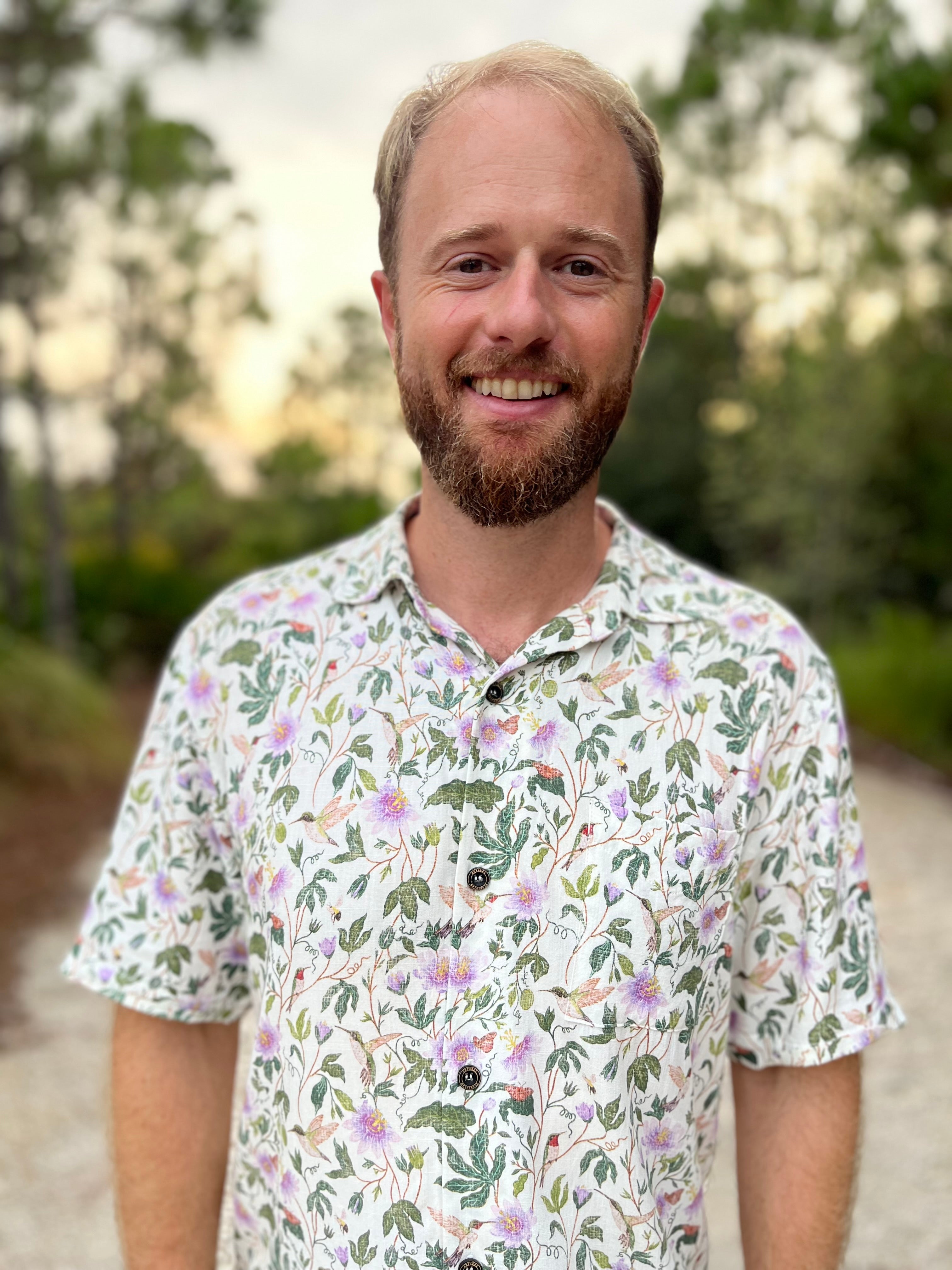 A man wearing the Passionflower Floridian Shirt by Okihasi.