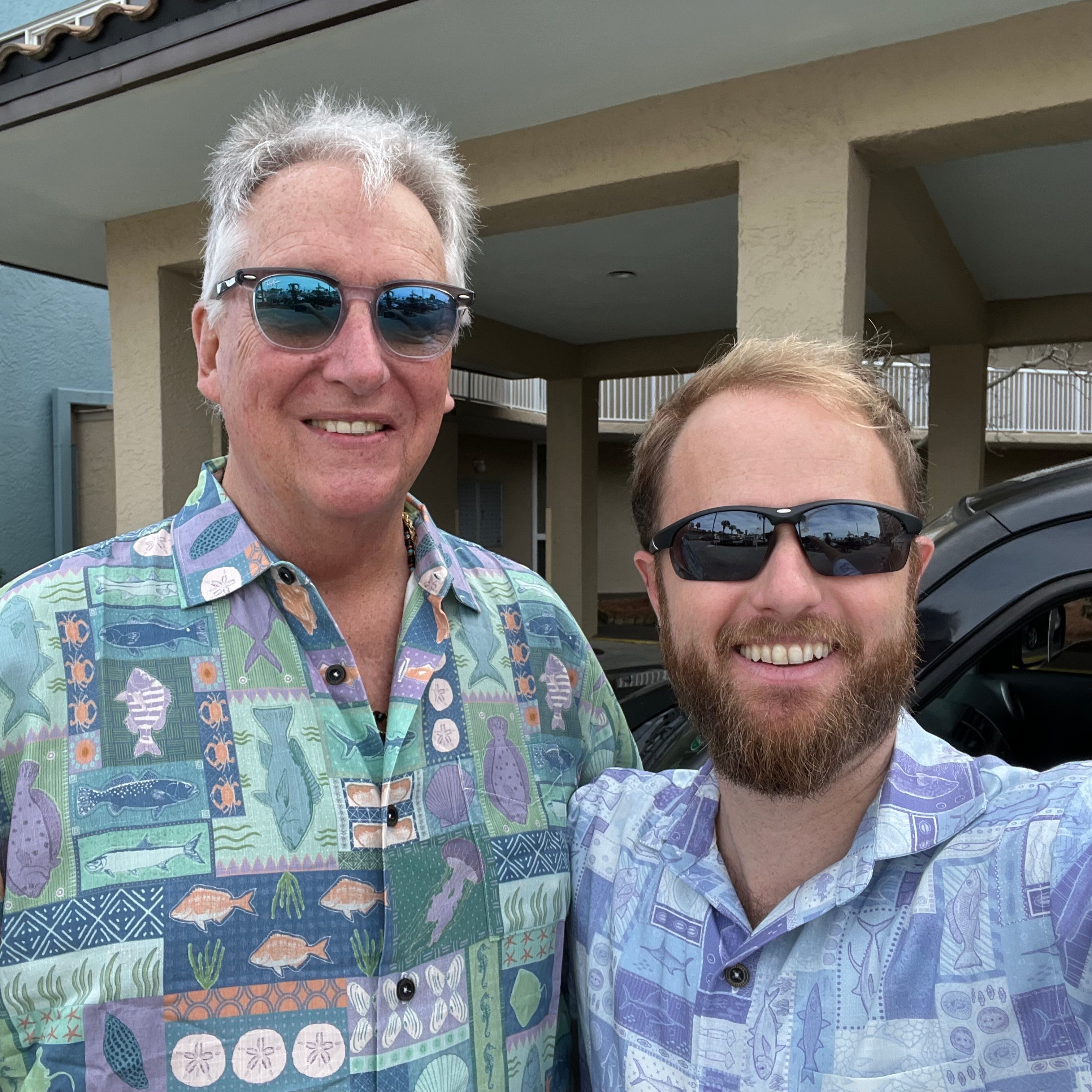 A man wearing the Inland Fish Floridian Shirt by Okihasi standing with another man.