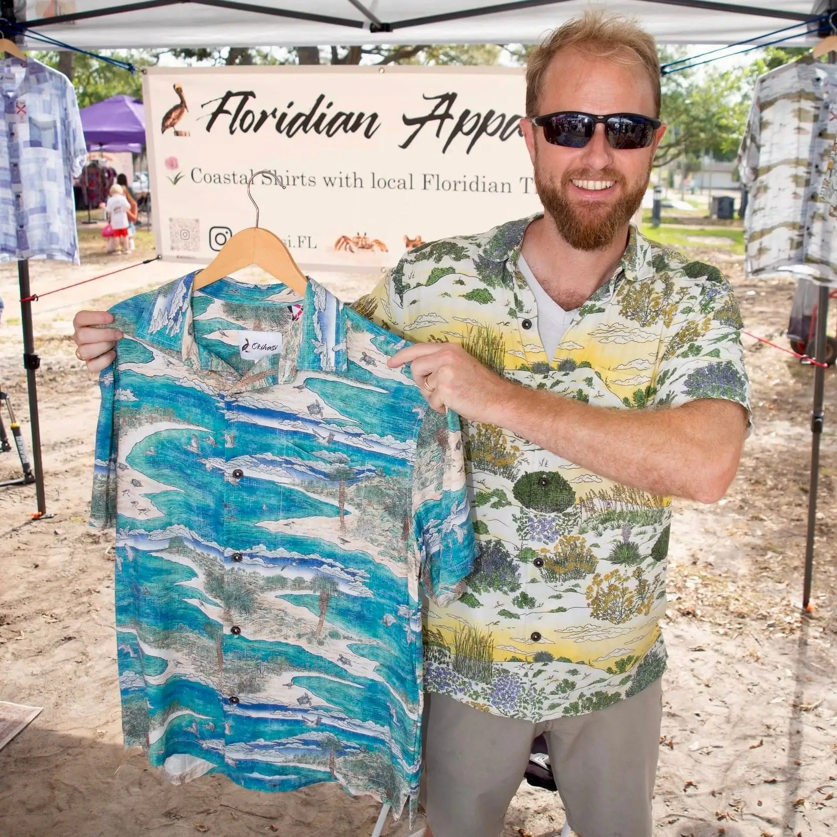 A man holding the Barrier Island Floridian Shirt by Okihasi.