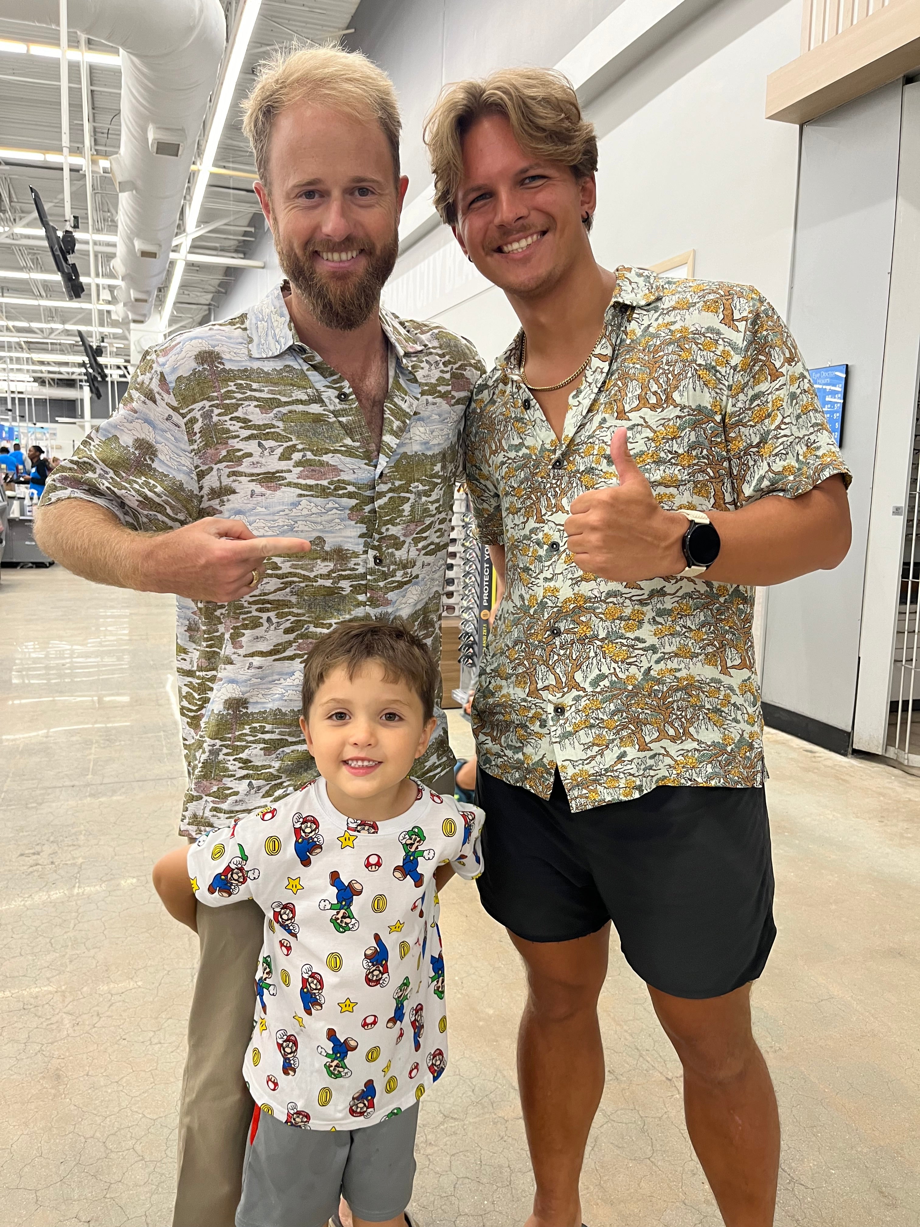 A man wearing the Salt Marsh Floridian Shirt by Okihasi (left side) with his son and another man on the right side.