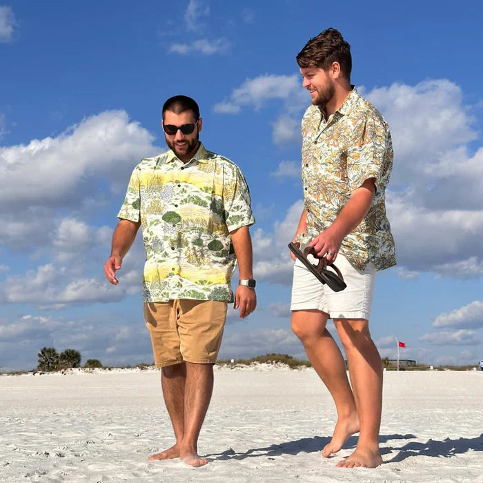 Two men wearing Okihasi shirts walking on the sand at the beach in Florida.